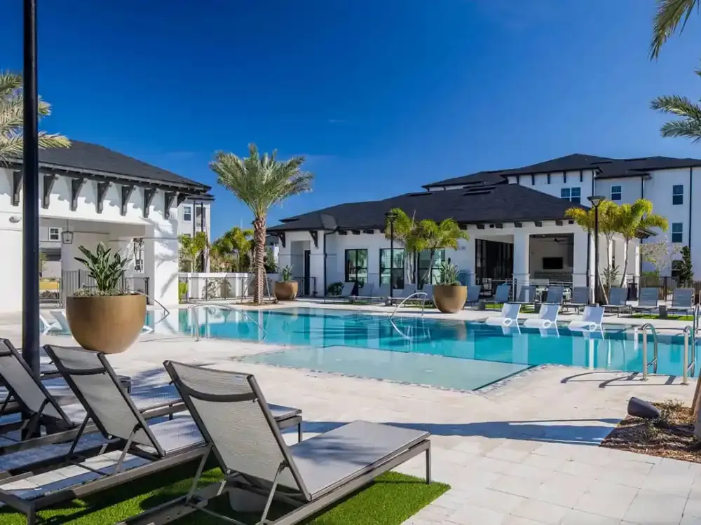 Commercial pool deck with loungers at an apartment community