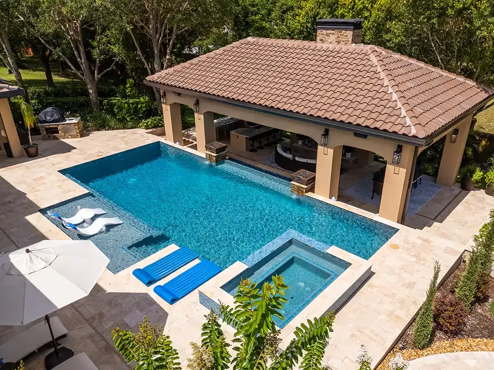 Aerial view of a backyard pool, spa and covered cabana